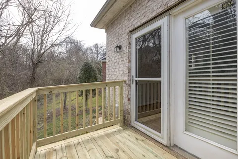 a view of a wooden house and a yard