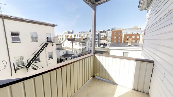a view of a balcony with furniture