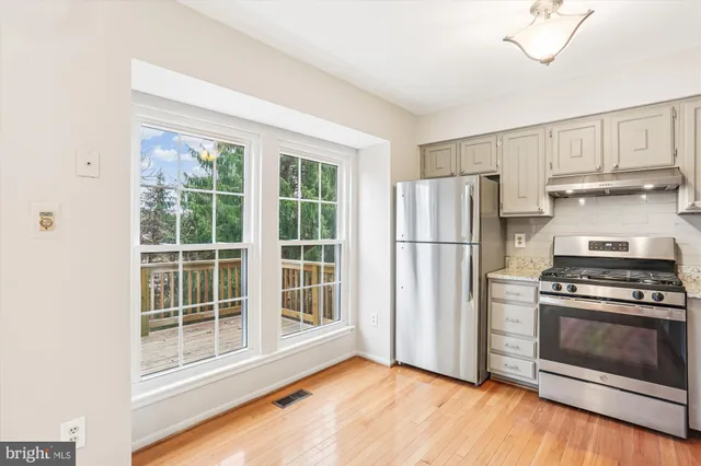 a kitchen with a sink cabinets and wooden floor
