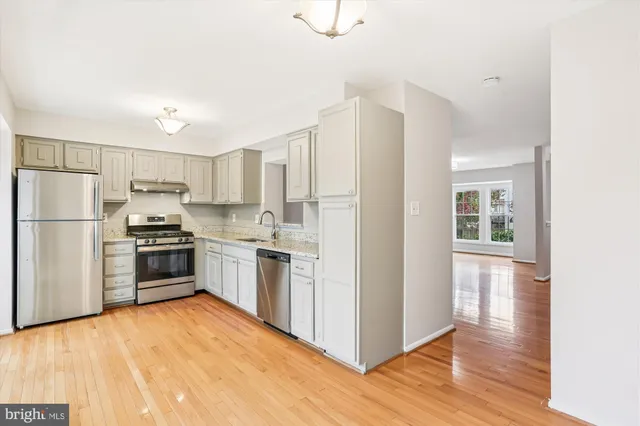 a view of a dining room with furniture large windows and wooden floor