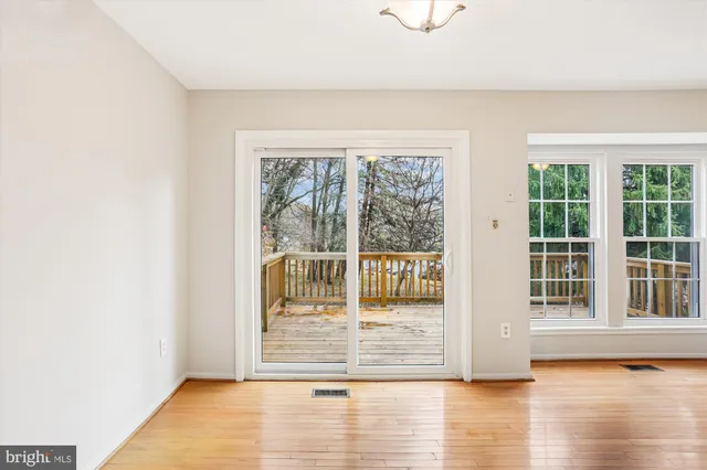 a view of a kitchen with wooden floor and electronic appliances