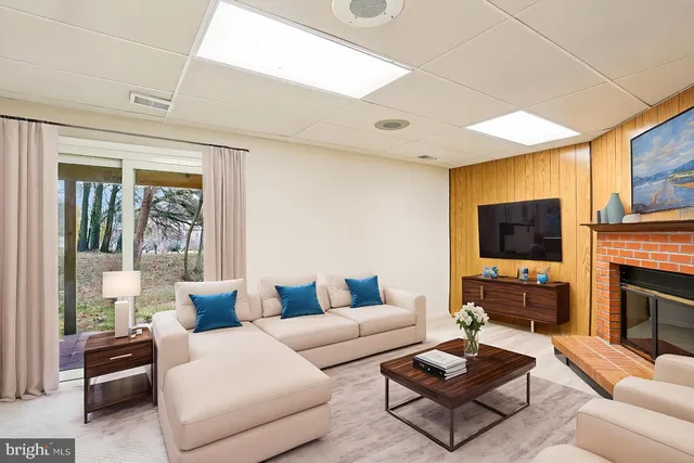 a view of an empty room with a fireplace and a window