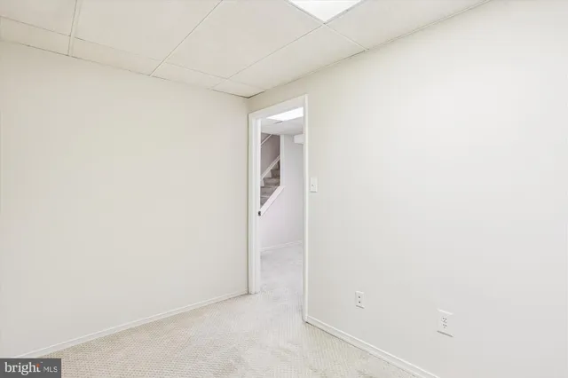 a porch with a table and chairs next to a yard