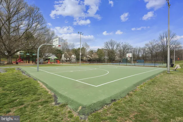 a tennis court with trees in the background