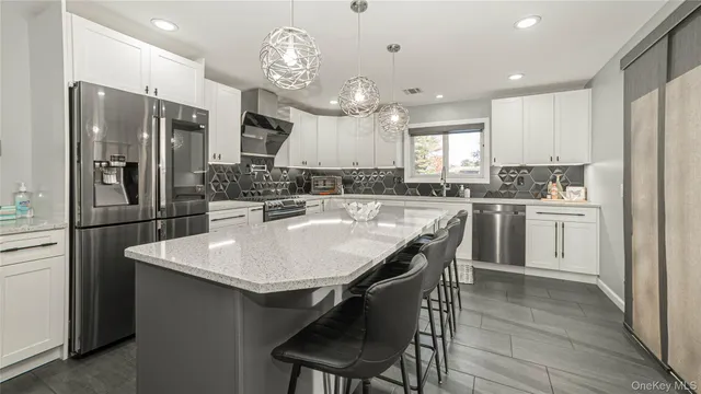 a kitchen with a dining table chairs sink and cabinets