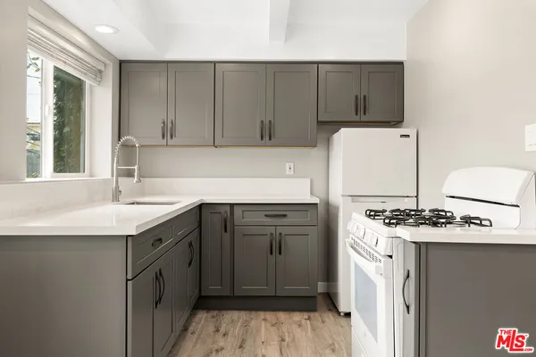 a kitchen with a sink stove and cabinets