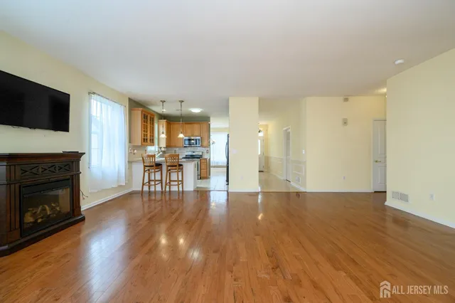 a view of a livingroom with furniture wooden floor and a fireplace