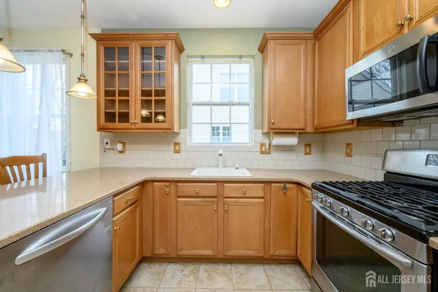 a kitchen with stainless steel appliances granite countertop a stove and a sink