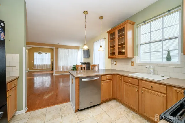 a kitchen with a sink window and cabinets