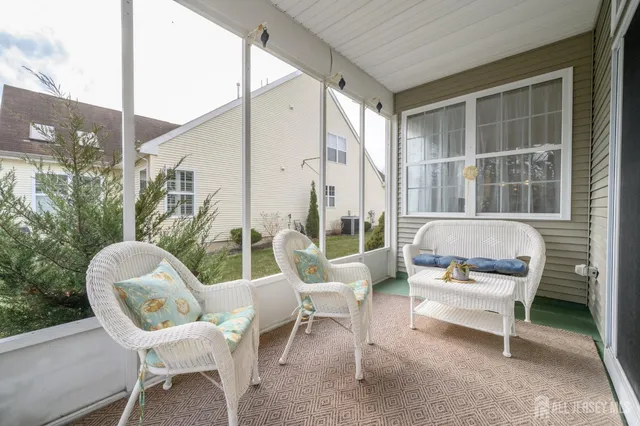 a view of a chair and tables in the balcony