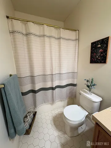 a white toilet sitting next to a bathroom sink