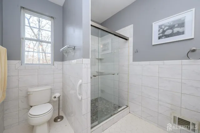 a bathroom with a toilet and a shower