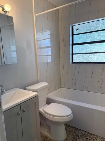 a bathroom with a sink a toilet and bathtub