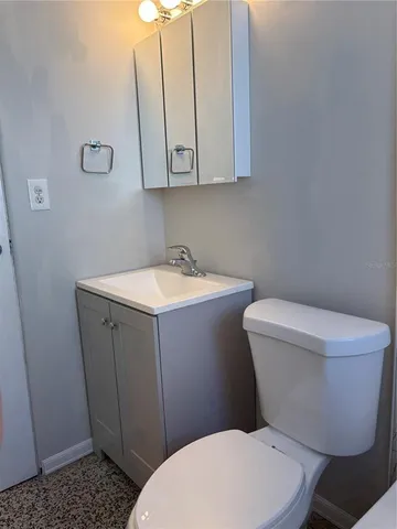 a white toilet sitting next to a bathroom sink