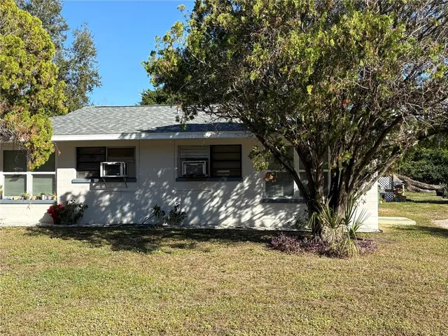 a front view of a house with a yard garage and outdoor seating