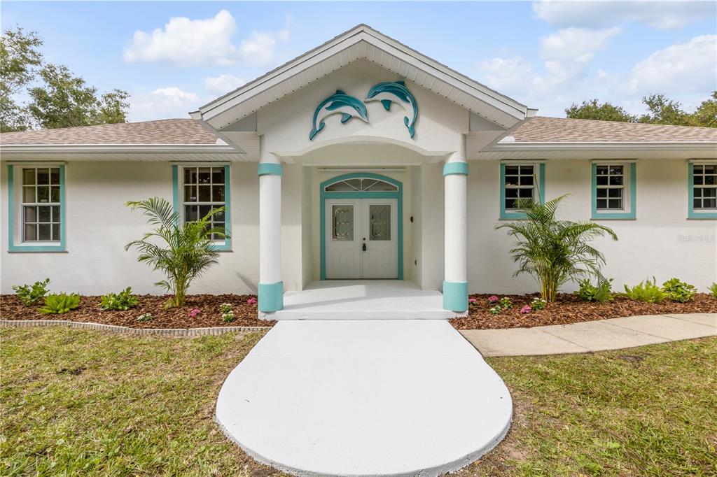3033 Turnbull Bay Road New Smyrna Beach, FL 32168 - Photo 1 of 54 a view of a house with potted plants