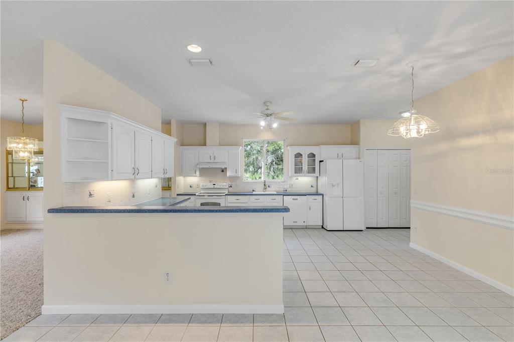 3033 Turnbull Bay Road New Smyrna Beach, FL 32168 - Photo 13 of 54 a kitchen with stainless steel appliances granite countertop a sink and cabinets