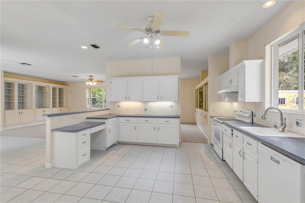 3033 Turnbull Bay Road New Smyrna Beach, FL 32168 - Photo 15 of 54 a large white kitchen with a large window