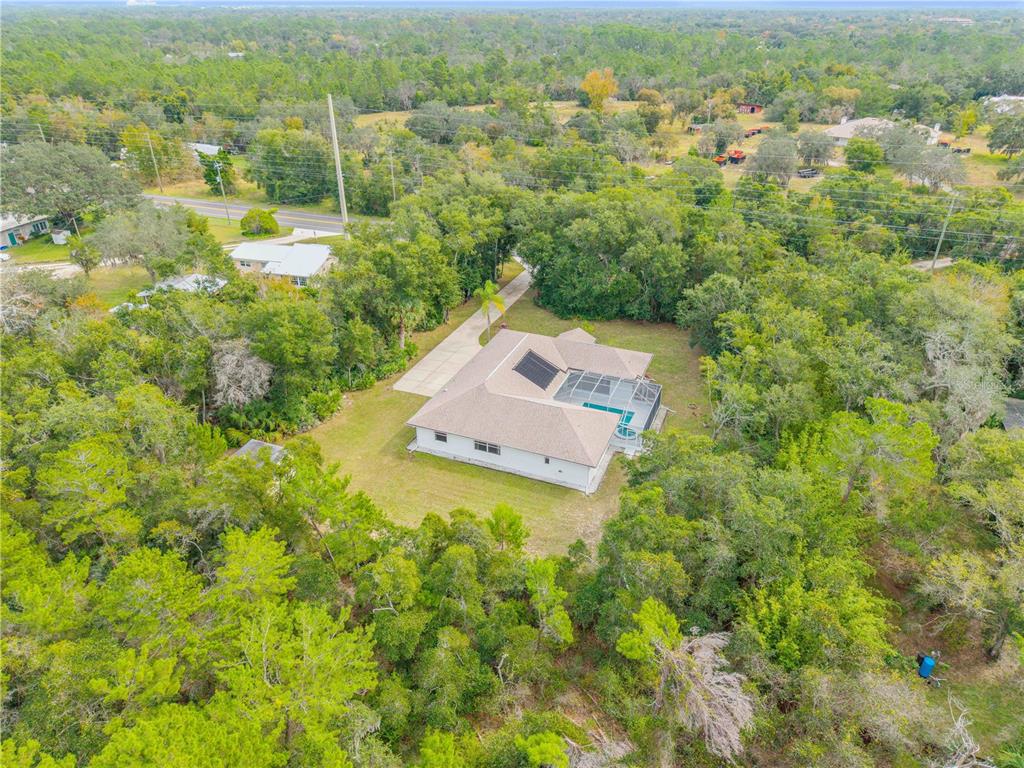 3033 Turnbull Bay Road New Smyrna Beach, FL 32168 - Photo 2 of 54 an aerial view of residential house with outdoor space and trees all around