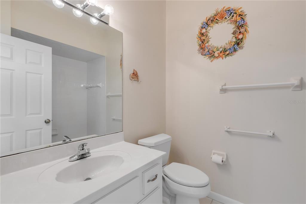 3033 Turnbull Bay Road New Smyrna Beach, FL 32168 - Photo 21 of 54 a bathroom with a sink mirror and toilet