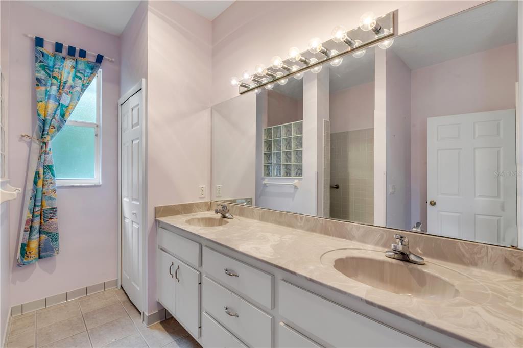3033 Turnbull Bay Road New Smyrna Beach, FL 32168 - Photo 25 of 54 a bathroom with a granite countertop sink and a mirror