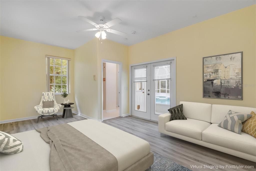 3033 Turnbull Bay Road New Smyrna Beach, FL 32168 - Photo 29 of 54 a bedroom with a large bed couch and two window