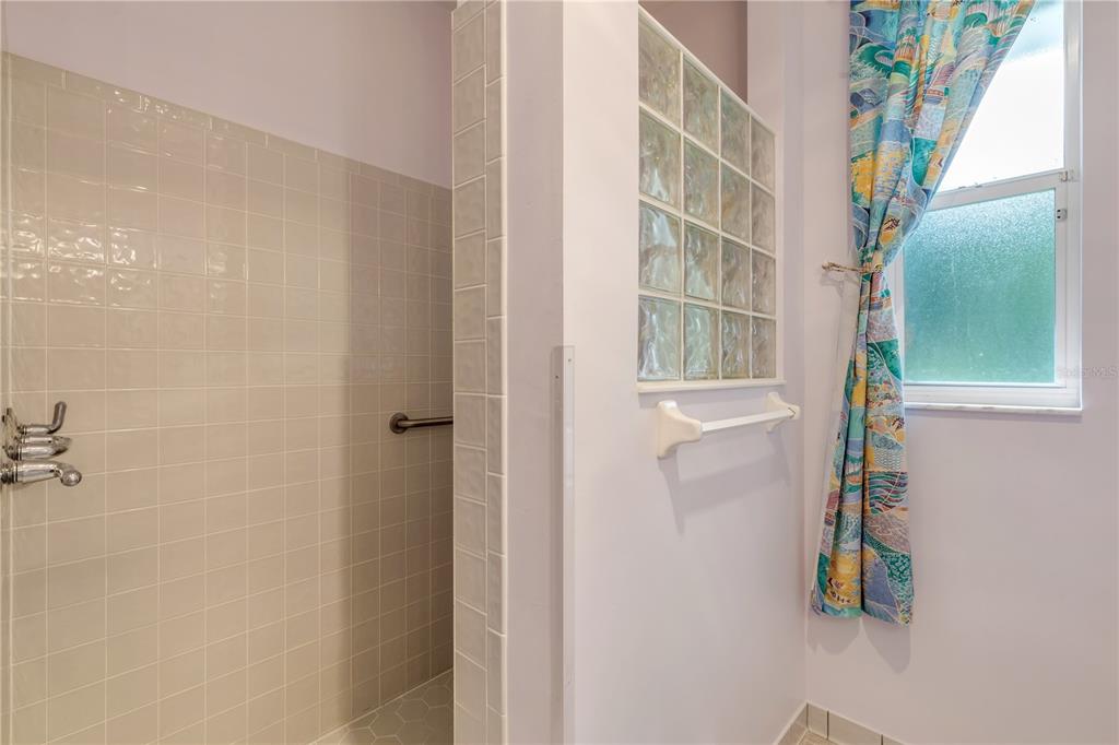 3033 Turnbull Bay Road New Smyrna Beach, FL 32168 - Photo 36 of 54 a bathroom with a shower and a window