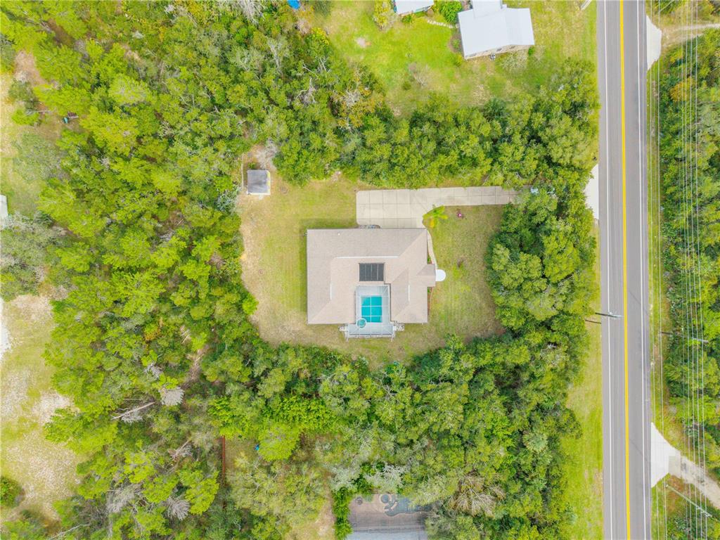 3033 Turnbull Bay Road New Smyrna Beach, FL 32168 - Photo 52 of 54 a view of a house with a yard