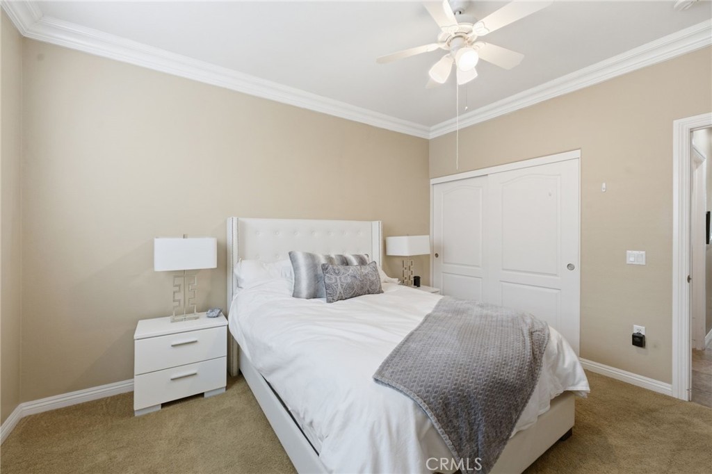 7975 Doyle Circle Hemet, CA 92545 - Photo 13 of 29 a bedroom with a bed and a ceiling fan