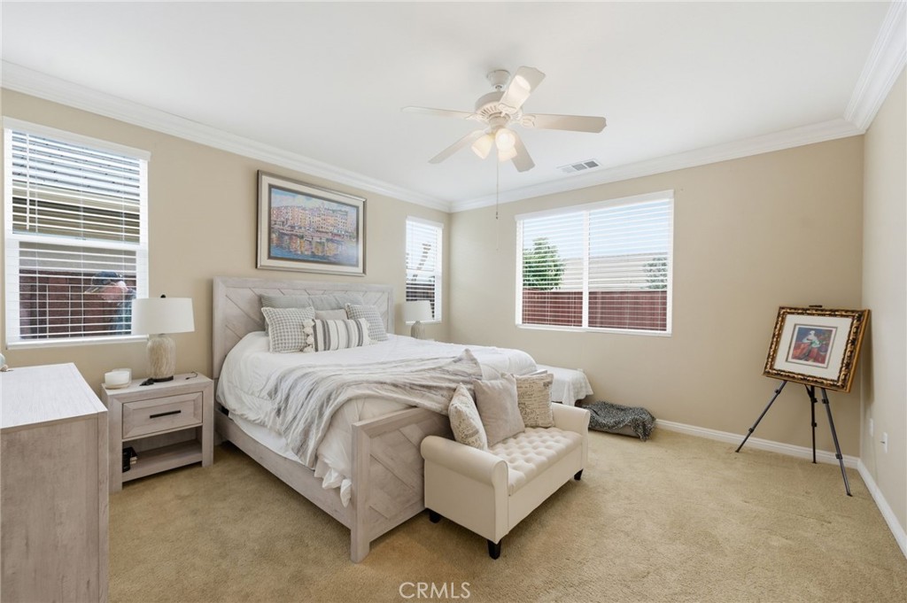 7975 Doyle Circle Hemet, CA 92545 - Photo 14 of 29 a spacious bedroom with a bed and a window