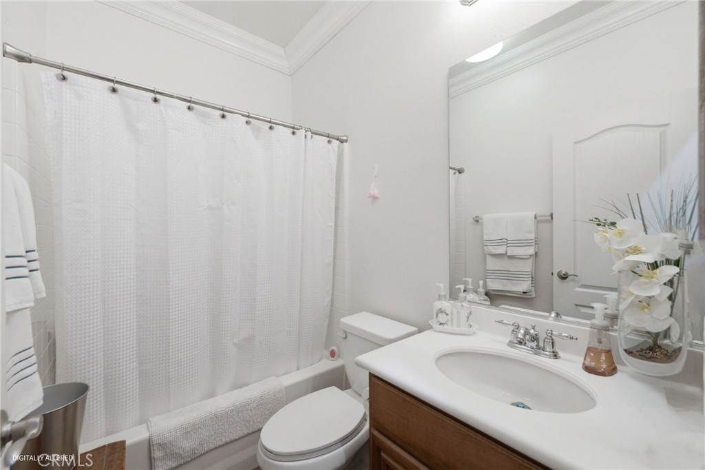 7975 Doyle Circle Hemet, CA 92545 - Photo 17 of 29 a bathroom with a sink a toilet and a mirror