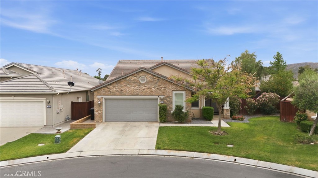 7975 Doyle Circle Hemet, CA 92545 - Photo 2 of 29 a front view of a house with a yard and garage