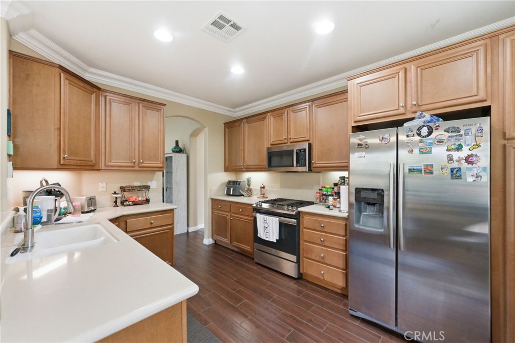 7975 Doyle Circle Hemet, CA 92545 - Photo 8 of 29 a kitchen with stainless steel appliances granite countertop a refrigerator stove microwave and sink