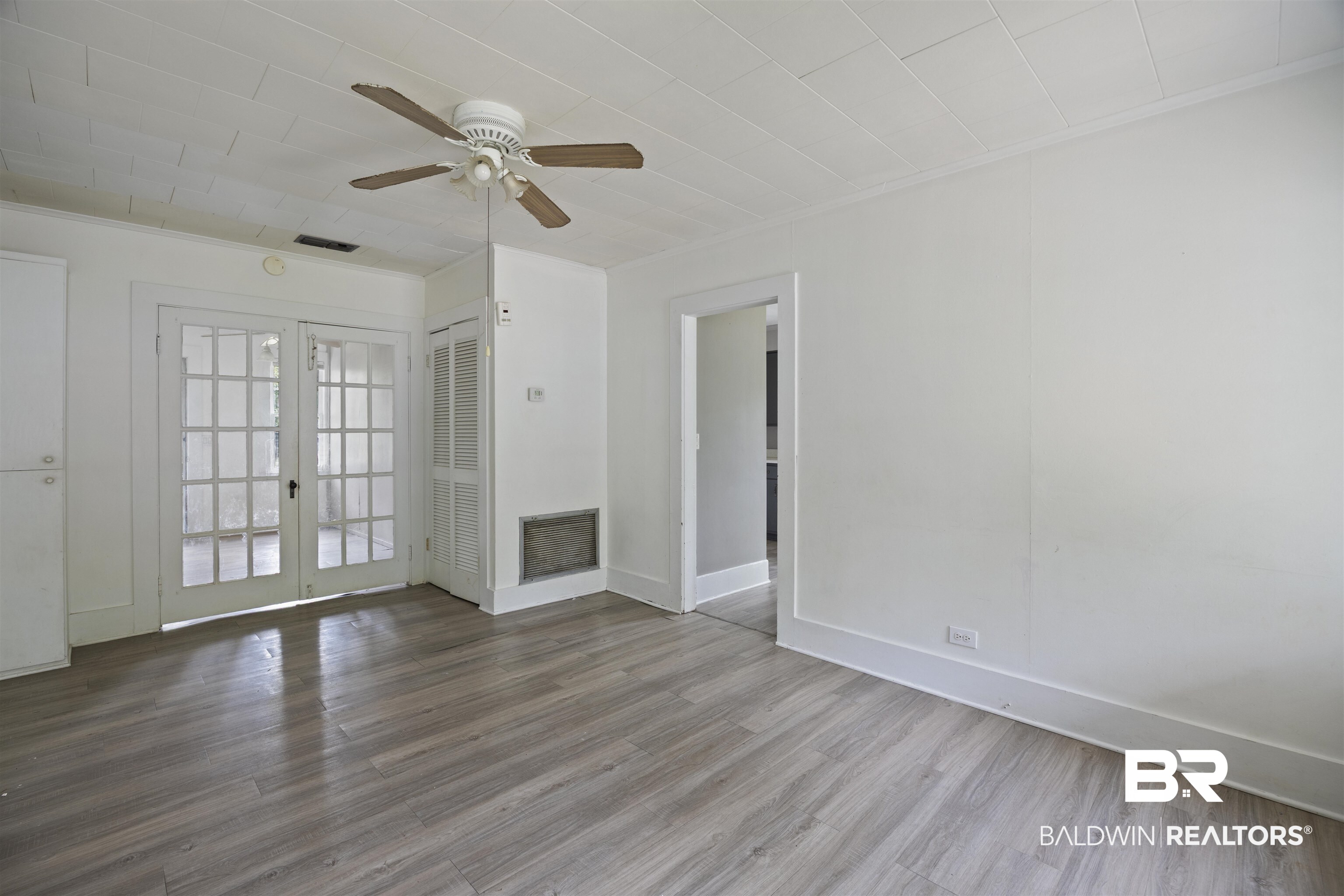 112 South Juniper Street Foley, AL 36535 - Photo 38 of 64 Unfurnished living room featuring a ceiling fan, wood finished floors, french doors, and ornamental molding