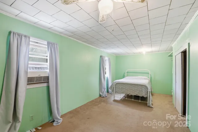 a room that has a bed and a chair in it