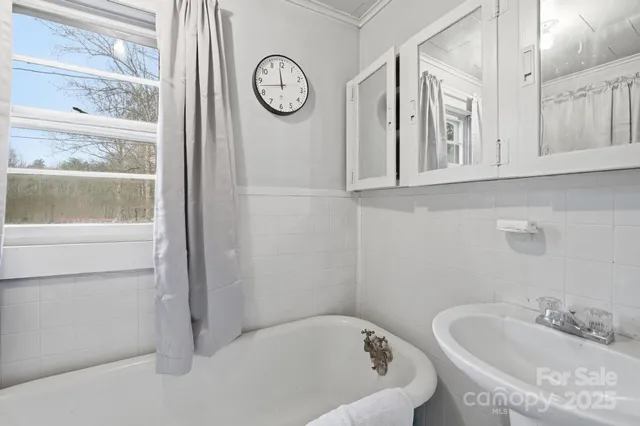 a bathroom with a bathtub and a window