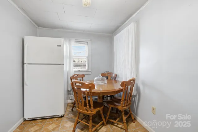 a view of a dining room with furniture and a window