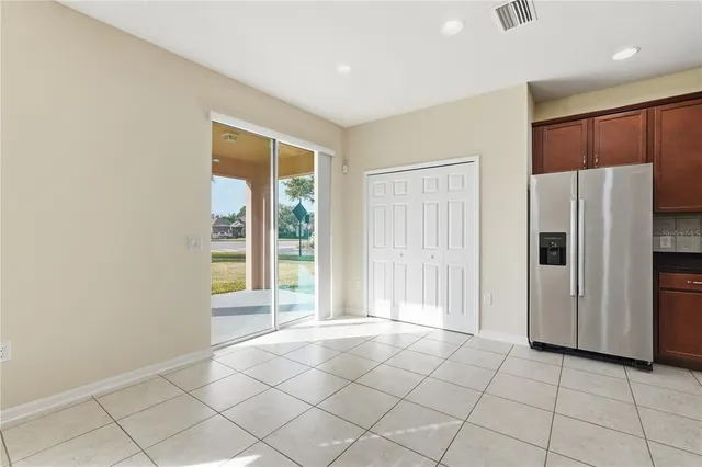 a view of a kitchen with a refrigerator cabinet and a window