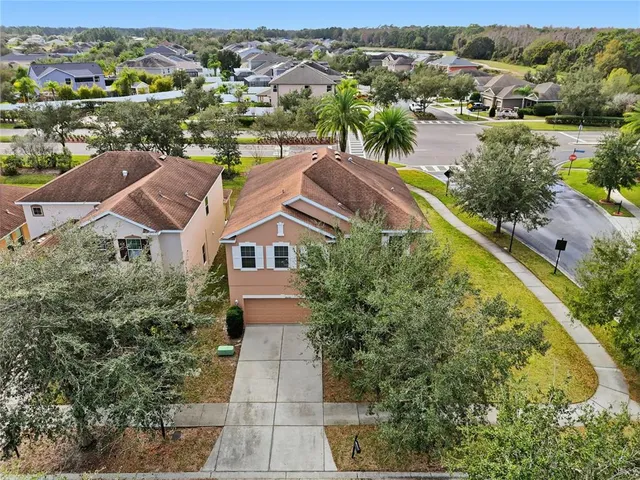 an aerial view of residential houses with outdoor space and river