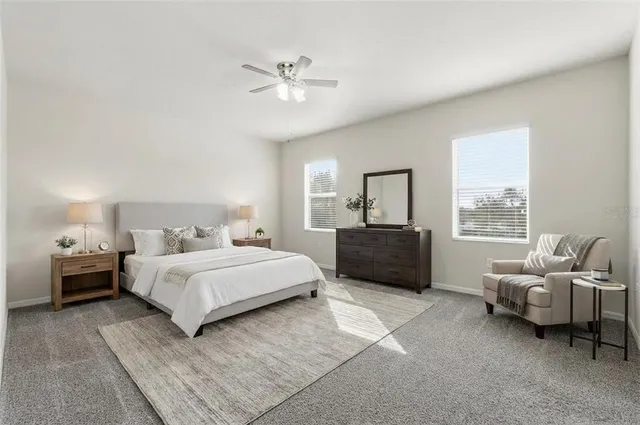 a spacious bedroom with a bed and furniture