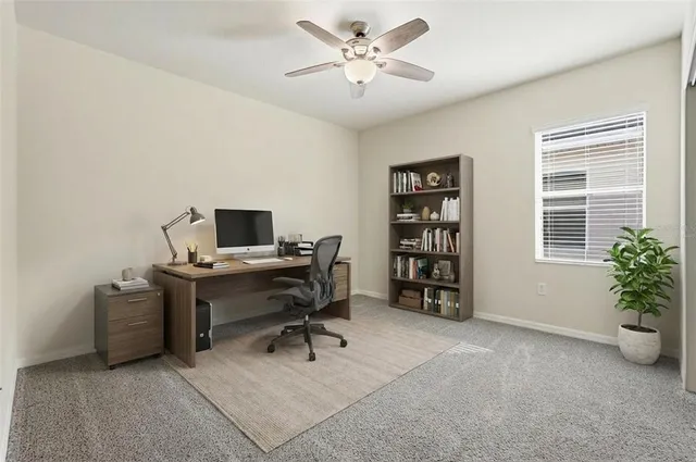 a view of a workspace with a window and a couch