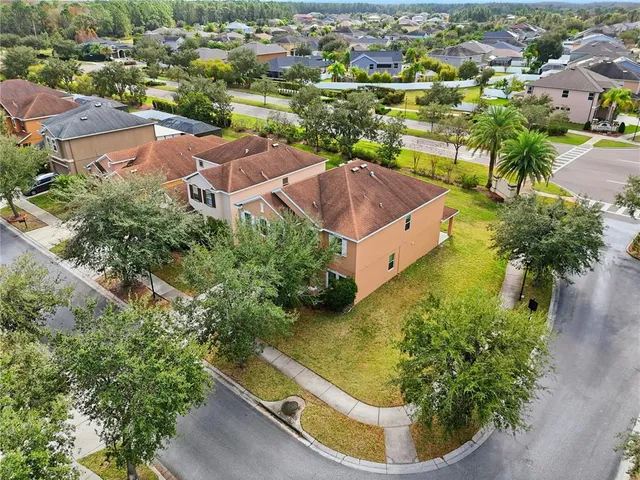 an aerial view of residential houses with outdoor space and swimming pool
