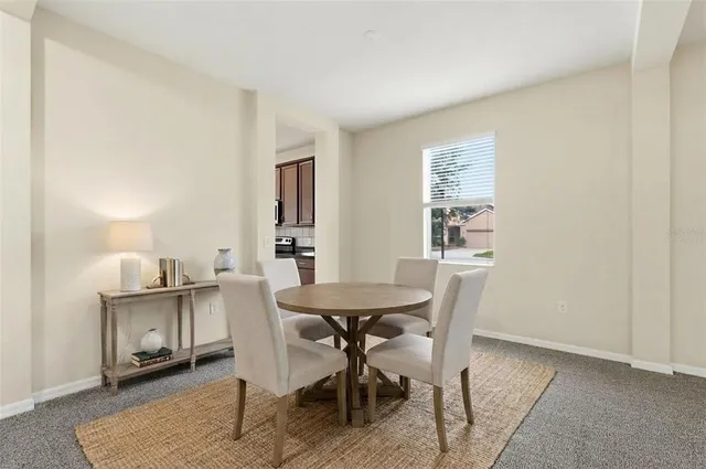 a dining room with furniture and window
