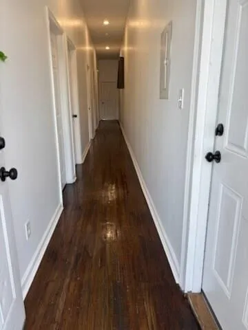 a view of a hallway with wooden floor