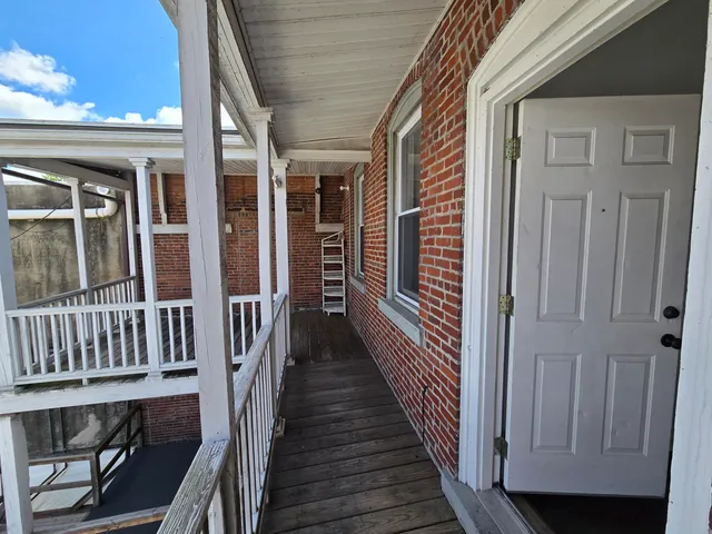 a view of a balcony with wooden floor