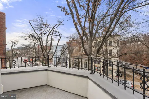 a view of balcony with large trees