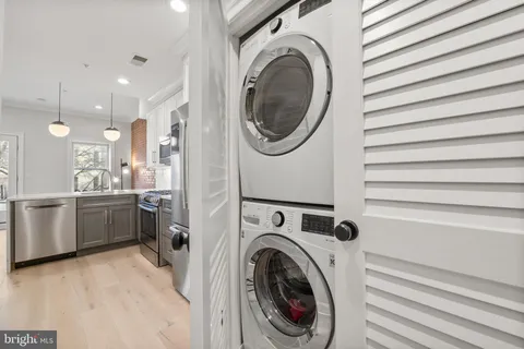 a view of a kitchen with a washer and dryer