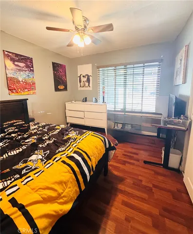 a bed room with furniture and wooden floor