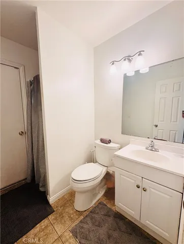 a bedroom with bed and wooden floor