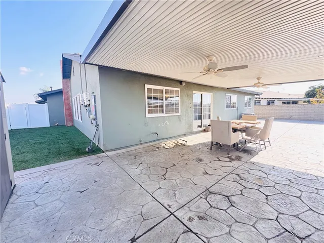 a view of a porch with a table and chair under an umbrella
